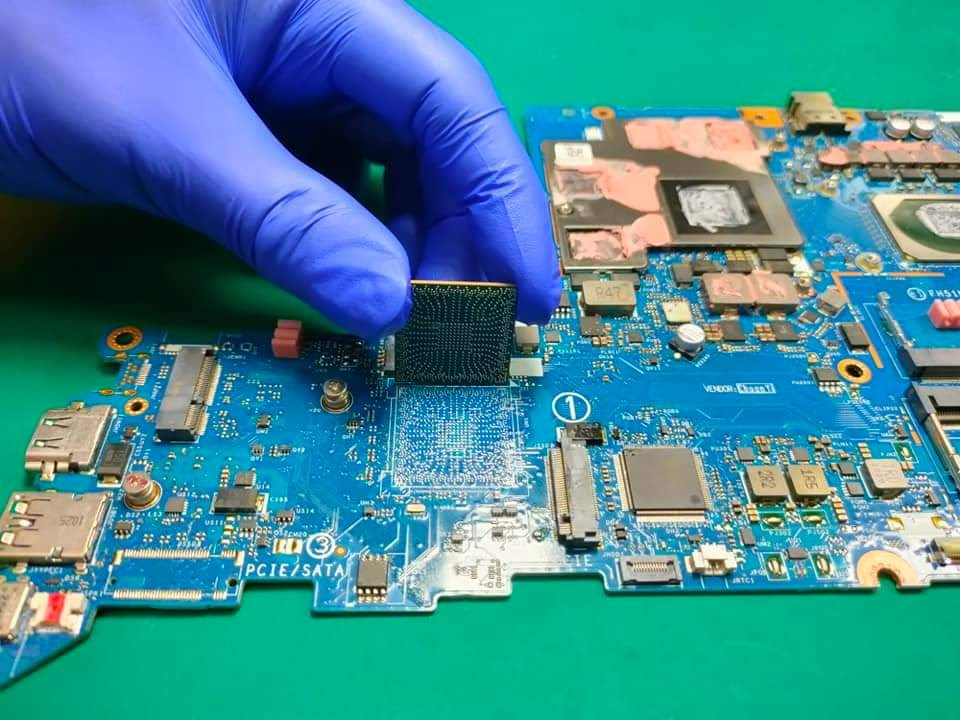 BGA CPU being placed on laptop motherboard during reballing repair